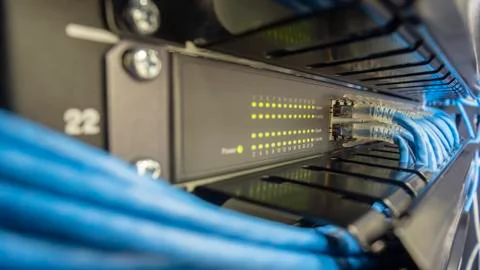 Network switch hub in rack cabinet. Network connection technology. Stock Photos