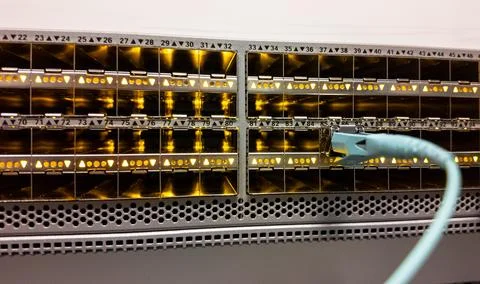 Network switch with numerous ports actively connected in a data center setup Stock Photos