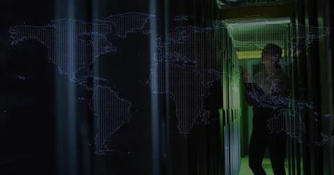 Network tech scanning server racks with tablet in data center corridor, map Stock Photos