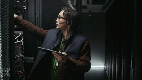 Network Technician Checking Server Connections in Data Center Stock Footage 330542801