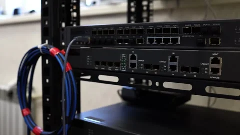 Network technician connects and checks cables on a network switch Stock Footage 278149950