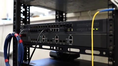 Network technician connects and checks cables on a network switch Stock Footage 278149951
