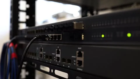 A network technician connects and tests modules on a network switch. Stock Footage 278149967