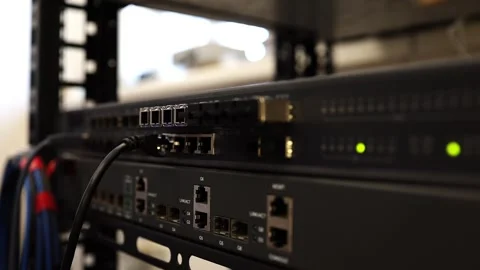 A network technician connects and tests modules on a network switch. Stock Footage 278149968