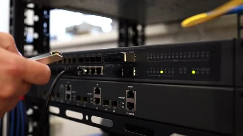 A network technician connects and tests modules on a network switch. Stock Footage 278149970