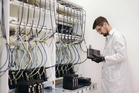 Network technician testing modems Stock Photos