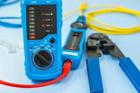 Network tester, patching cord, and network tool are blurred Stock Photos