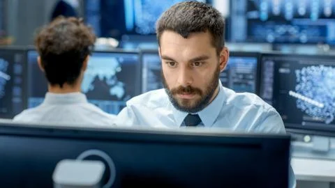 Neural Network and Machine Learning Engineer Programming at His Workstation.  Stock Photos