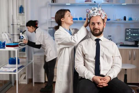 Neurologist doctor analysing brain of man and nervous system Stock Photos