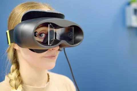 Neurologist performing positional testing of patient using videonystagmogra.. Stock Photos