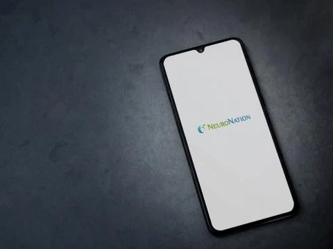 NeuroNation app launch screen with logo on the display of a black mobile smar Stock Photos