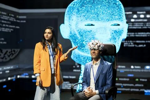 Neuroscientist showing EEG brain interface at conference Stock Photos