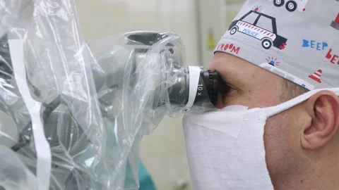 Neurosurgeon looks through a microscope Stock Footage 152945064