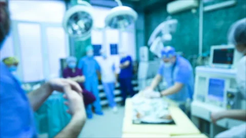 Neurosurgeons perform surgery to excise a brain tumor in a modern surgical Stock Footage 103103308