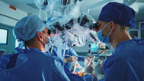 Neurosurgeons performing operation looking constantly into binoculars of microsc Stock-Footage 221003016