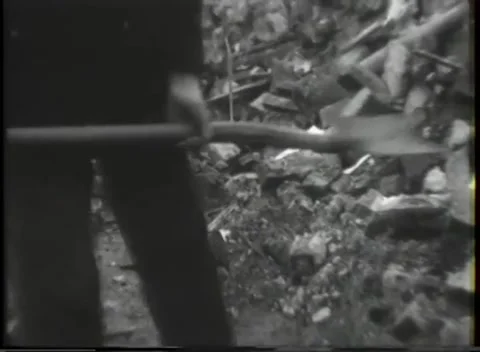 NEUSS - 1945: Bomb damage - Shadowed worker stands amid broken timbers 스톡 동영상 343849385