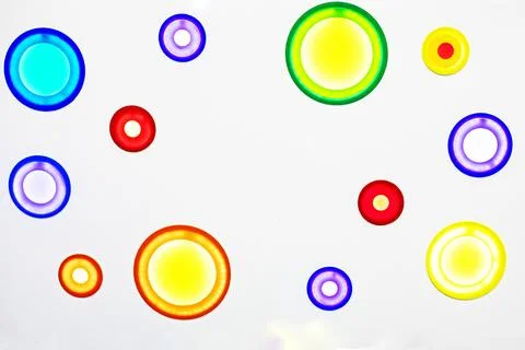 Neutral background with multicolored glowing circles in a shopping mall 스톡 사진