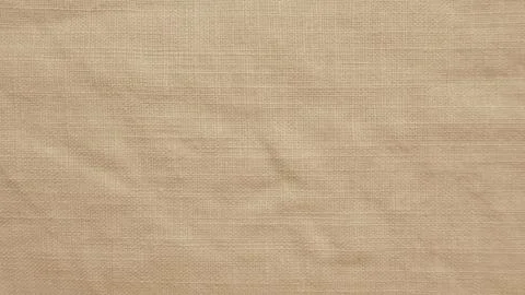 Neutral beige linen fabric texture close up showing natural woven organic cot Foto stock