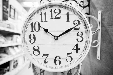 Neutral colored clock in classic style. Stock Photos