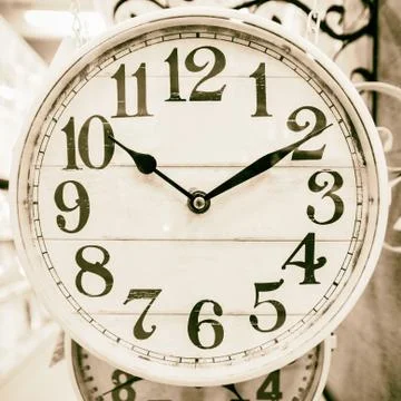 Neutral colored clock in classic style. Stock Photos