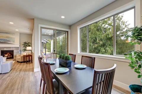Neutral dining room interior fitted with black dining table lined by high bac Stock Photos