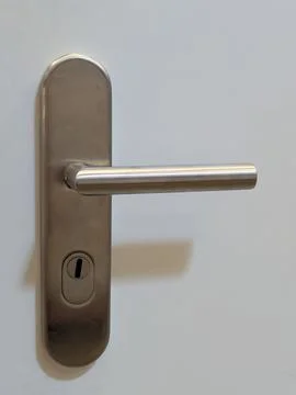 Neutral door handle in indoor setting with metallic texture and silver and .. Stock Photos