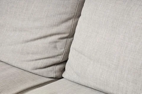 Neutral gray fabric sofa texture with seam detail, modern home furniture upho Stock Photos