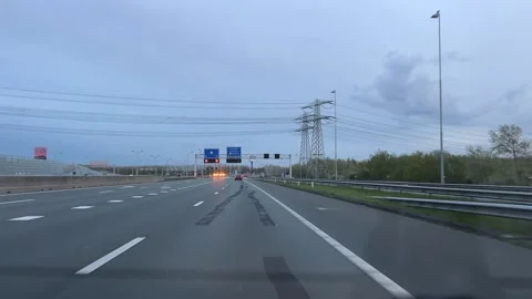 Neutral highway driving continuous forward motion on a roadside with signs and 스톡 동영상 342756222