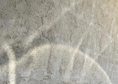 Neutral Rough Plaster Surface with Natural Sunlight Reflections 库存照片