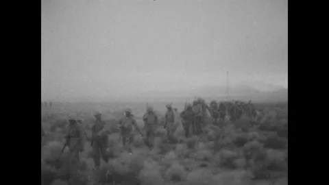 NEVADA - 1950s - US Marines march out to a desert atomic bomb testing site where Stock Footage 340587477