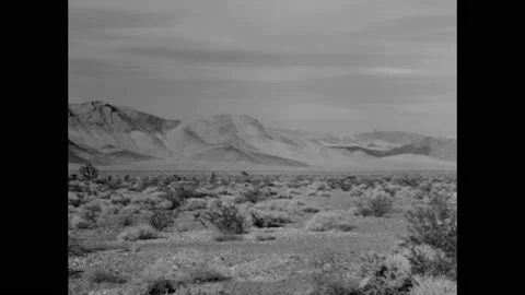 NEVADA - 1963 - A panorama of the Nevada Test Site has a narrator wondering if 스톡 동영상 323083647