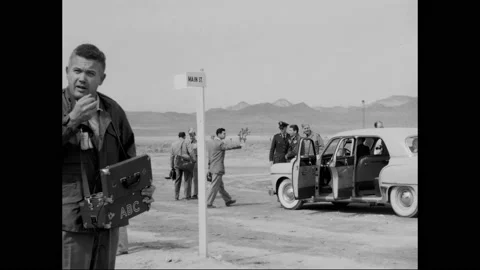 NEVADA - 1963 - A reporter visits "Doom Town," an area of test houses on the 스톡 동영상 323082670
