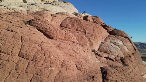 Nevada Red Rock Cliffs With Rock Climbers Ascending in Background 動画素材 245671552