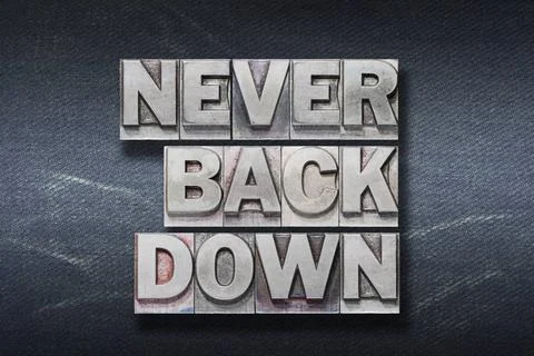 Never back down den never back down phrase made from metallic letterpress ... Stock Photos