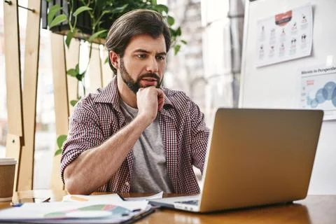 Never give up. Keep chasing your dreams. Software developer sitting with laptop Stock Photos