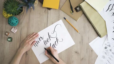 Never give up In A Paper Card Written In Calligraphy Form Drawing twirl Stock Footage 148693343