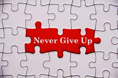 Never give up text on missing jigsaw puzzle. Motivational and inspirational Foto stock