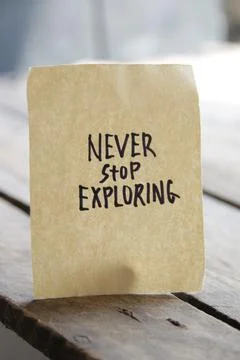 Never stop exploring idea. Writing on a piece of paper Stock Photos