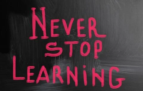 Never stop learning handwritten with chalk on a blackboard Illustrazione stock