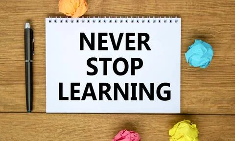 Never stop learning symbol. Words 'Never stop learning' on white note on beau Stock Photos