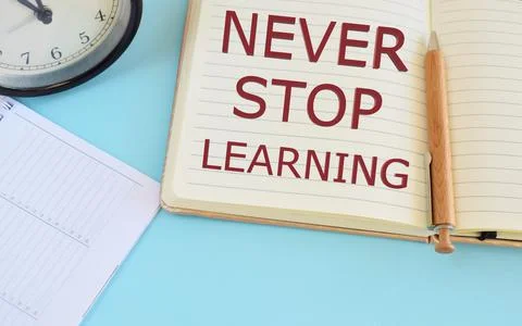 Never stop learning text written in Notebook. Learning concept. Stock Photos