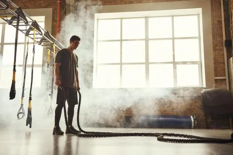 Never stop. Side view of young athletic man with perfect body doing crossfit Stock Photos