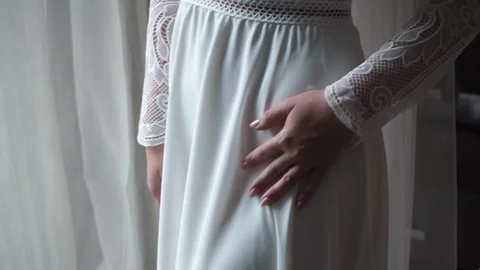 невеста в платье стоит у окна Stock Footage 159882127