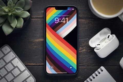 The new 14 iPhone pro max with the original screensaver rainbow wallpaper on the Stock Photos
