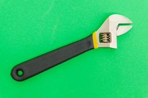 New adjustable spanner on a green background Stock Photos