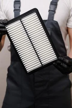 New air filter in hands of car mechanic, close-up. Concept for auto parts Stock Photos
