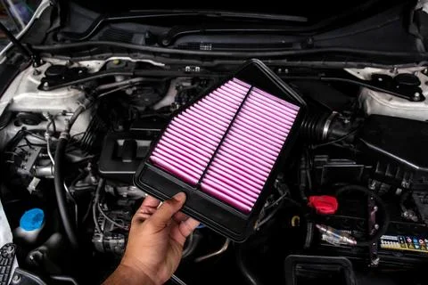 New air filter replacement by auto mechanic in auto repair garage Stock Photos