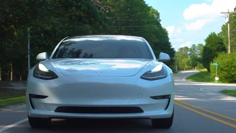 New all electric Tesla Model 3 driving down the road. Stock Footage 95664646