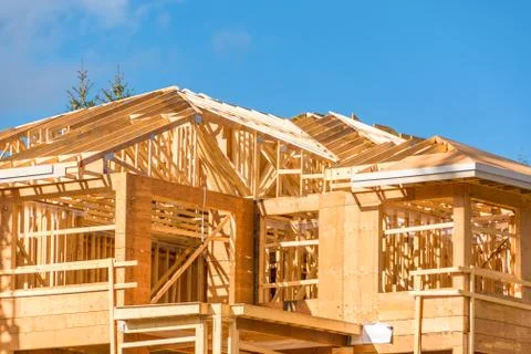 New apartment building under construction on sunny day on blue sky background. Stock Photos