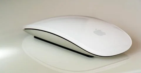 New Apple Computers magic mouse on glass reflective surface Stock Photos